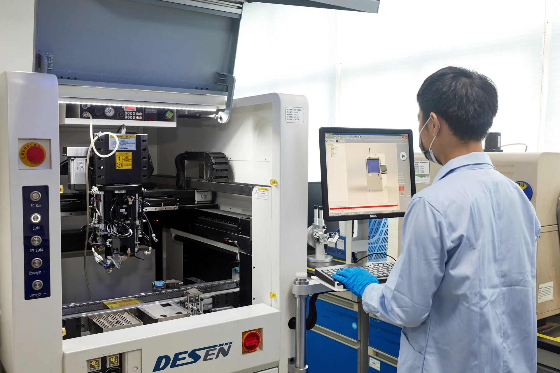 Engineer operating precision dispensing equipment in the research institute